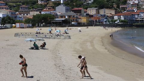 Ba�istas, este lunes por la ma�ana, en la playa de A Banda do R�o de Bueu, en el casco urbano