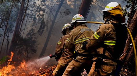 Varios bomberos tratan de apagar las llamas en Calheta, en la isla de Madeira