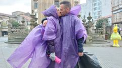 Melody y Jorge, con sus impermeables, celebrando con un besazo en Pontevedra que se hicieron novios en el Camino Portugu�s.