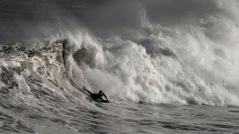 Un hombre practica bodysurf en la playa de San Lorenzo de Gij�n