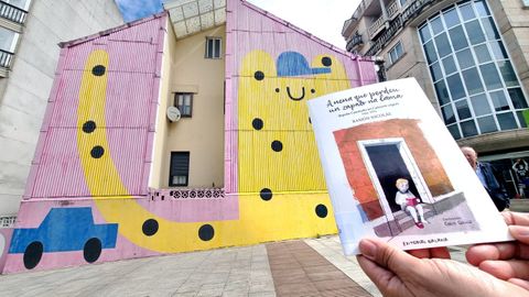 O escritor e cr�tico Ram�n Nicol�s co libro da s�a autor�a �A nena que perdeu un zapato na lama� diante da primeira casa na que viviu Bego�a Caama�o.