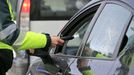 Un guardia civil realiza la prueba de alcoholemia a un conductor en una carretera de Lugo.
