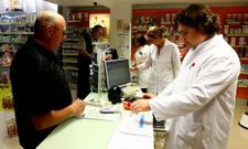 Dolores Casariego, en el centro, en la farmacia de la que es titular en Viveiro.