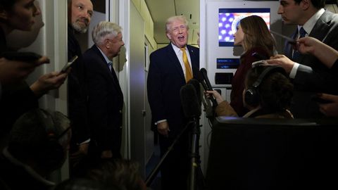 Trump, atendiendo a los medios a bordo del Air Force One