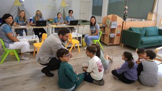 La enfermera Marta V&aacute;zquez, a la izquierda en la silla verde, durante la vacunaci&oacute;n en el CEIP A Xunqueira 2 de Pontevedra