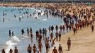 Varias personas disfrutan de un soleado da de verano en la playa de San Lorenzo en Gijn,