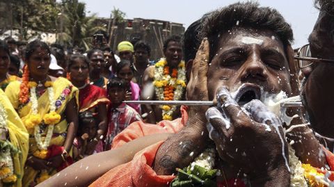 Un devoto indio de la comunidad tamil se agujerea la boca con una aguja antes de participar en la procesin de la festividad de Muthu Mariamman Puja en Bombay.