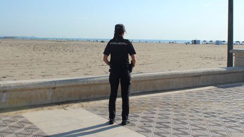 Una agente de la Polic�a Nacional patrulla las inmediaciones de la playa de La Malvarrosa en Valencia, en una imagen de archivo