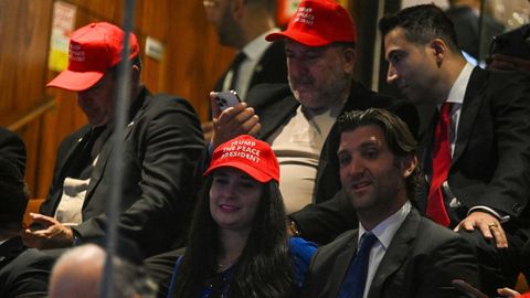 Un grupo de personas espera el discurso de Trump en el Parlamento hebreo. Han repartido gorras con el lema «Trump, the peace president»