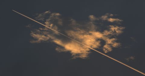 A estela dun avi�n atravesa o solpor da costa lucense. 15/07/2022