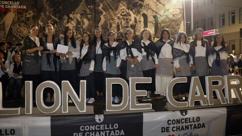 Miembros de los diferentes grupos participantes en el desfile de carros pasaron por el palco durante la entrega de los premios