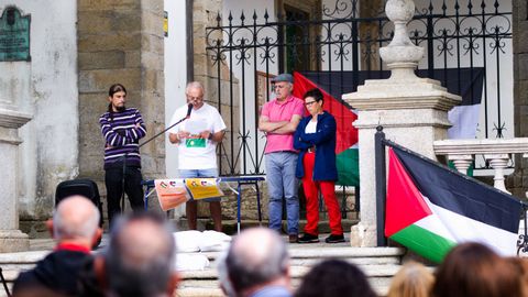 Los tres promotores del acto del sábado escuchan una de las lecturas del acto, con banderas palestinas