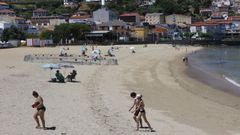 Ba�istas, este lunes por la ma�ana, en la playa de A Banda do R�o de Bueu, en el casco urbano