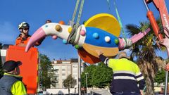 Operarios instalando en su lugar el p�jaro Peteiro