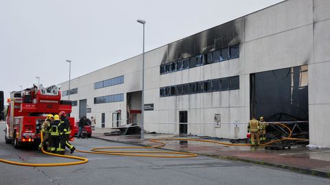 Los bomberos comarcales actuando en el incendio que arras� la nave de Trison en Sada
