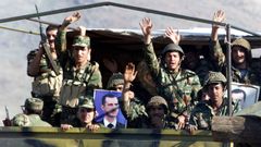 Soldados del Ej�rcito sirio posan con una foto del presidente Bachar al Asad