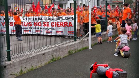 Un grupo de nios observa el paso de los cientos de personas que participan este lunes en la marcha a pie desde la planta de Vesuvius en Riao hasta el Ayuntamiento de Langreo para protestar contra la desindustrializacin de las cuencas mineras