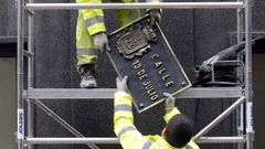 Dos operarios trabajan en la sustitucin de la placa de la calle 19 de Julio, en el centro de Oviedo, en aplicacin de la ley de Memoria Histrica por parte del Ayuntamiento de Oviedo