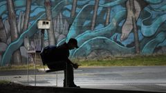 Una persona sentada en un banco en A Coru�a, en una imagen de archivo 