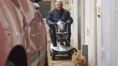 Junto a su inseparable perro Blacky, que esta cojo. Manuel Edreira, en la calle Andrs Dobarro, una va donde se encuentra en muchas ocasiones vehculos estacionados como el de la imagen y que le impiden seguir su camino, a veces tienen que esperar media hora bajo la lluvia. 