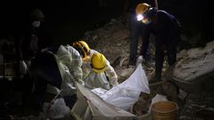 Personal de rescate cubre el cuerpo de una v�ctima tras los terremotos de Venezuela.
