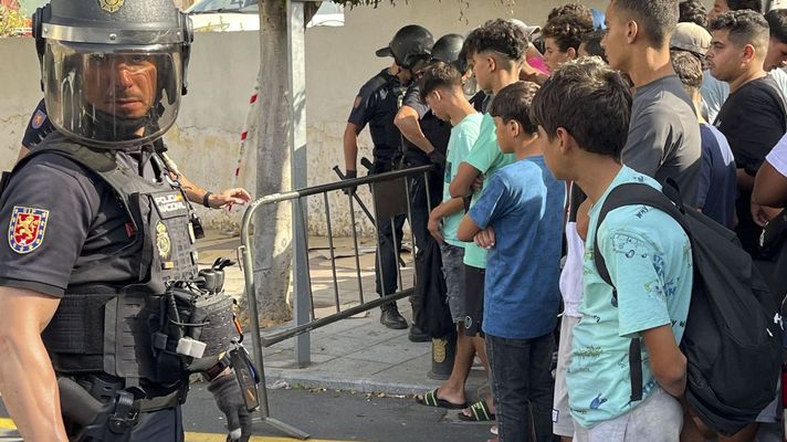 Menores migrantes esperan para su filiaci�n ante la Jefatura Superior de la Polic�a nacional en Ceuta.