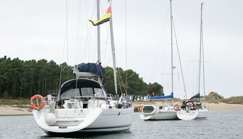 Embarcaciones participantes en la traves�a durante la parada en una de las playas de A Illa. 