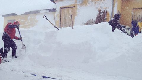Var�as personas tratan de desbloquear el acceso a uno de los edificios en Fuentes de Invierno