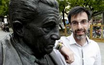 O escritor Pardo de Neyra posa xunto a estatua de Fole, en Lugo.