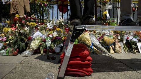 Pies de las personas que participan en la misa en el exterior de la Iglesia, ante el memorial por las v�ctimas mortales.