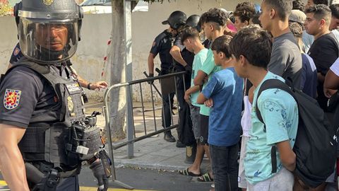 Menores migrantes esperan para su filiaci�n ante la Jefatura Superior de la Polic�a nacional en Ceuta.