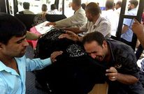 Un polic�a llora sobre el ata�d de un compa�ero asesinado en los atentados de ayer en Bagdad.