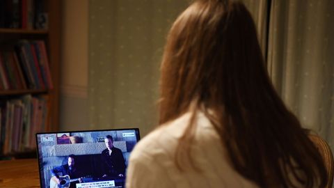 A girl watches US band  The Killers  during the 'One World: Together At Home' broadcast at her home in London, Britain