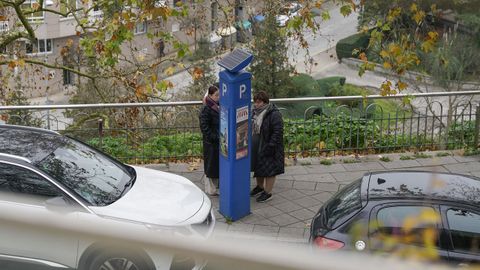 Usuarios retirando el tique de la ORA este viernes en uno de los parqumetros de la ciudad.