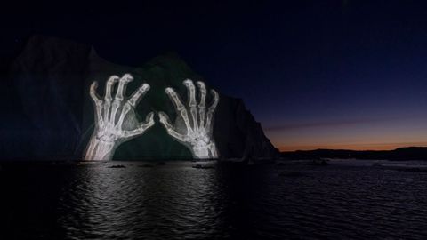 Iceberg iluminado en Groenlandia con imgenes que tratan de concienciar sobre el cambio climtico