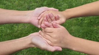 Las manos de Laura sostienen las de su hija.