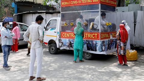Un grupo de personas espera en La India a hacerse an�lisis de coronavirus