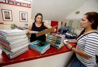 Mar�a Teresa Moledo y Diana Santos, en el banco de libros del colegio de A Escardia.