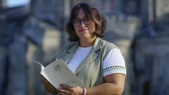 Carmen Jos&eacute; Mart&iacute;nez posa delante del templo de A Veracruz de O Carballi&ntilde;o con un ejemplar de su libro.