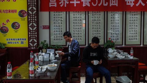 Dos clientes comen en un restaurante en China, el pas donde se origin la pandemia
