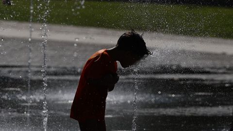 Un ni�o se refresca en los chorros de agua de Madrid R�o este viernes durante la ola de calor.