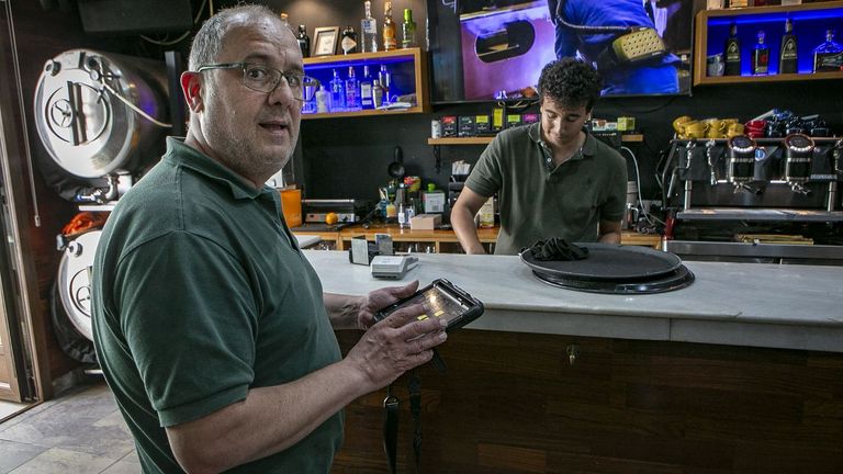 Juan Lij�, due�o del Bar Plaza, con uno de los camareros, Hatim