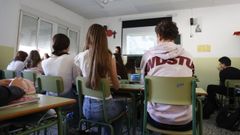Vista de una clase en la que un profesor y sus alumnos aplican el programa educativo