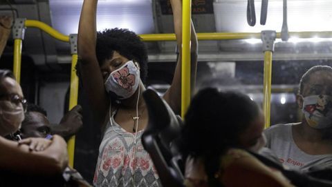 Pasajeros de un autob�s en R�o de Janeiro, portando mascarillas de protecci�n