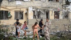 Un grupo de residentes abandonan sus viviendas durante un ataque ruso con drones en Odesa (Ucrania).