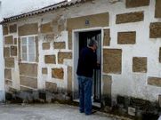 El afectado junto a la casa adquirida para su rehabilitación.