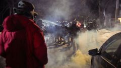 Un agente roc�a un agente qu�mico contra un manifestante la noche del jueves en Mine�polis.