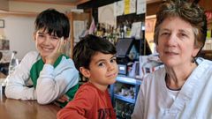 Milucha y sus nietos, Xoel y Lois, detr�s de la barra del bar al que ha dedicado buena parte de su vida