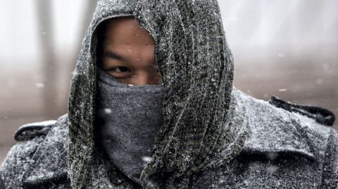 Un hombre camina bajo la nieve en Nueva York.