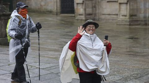 Dos peregrinos, bajo la lluvia de este fin de semana, en la plaza del Obradoiro